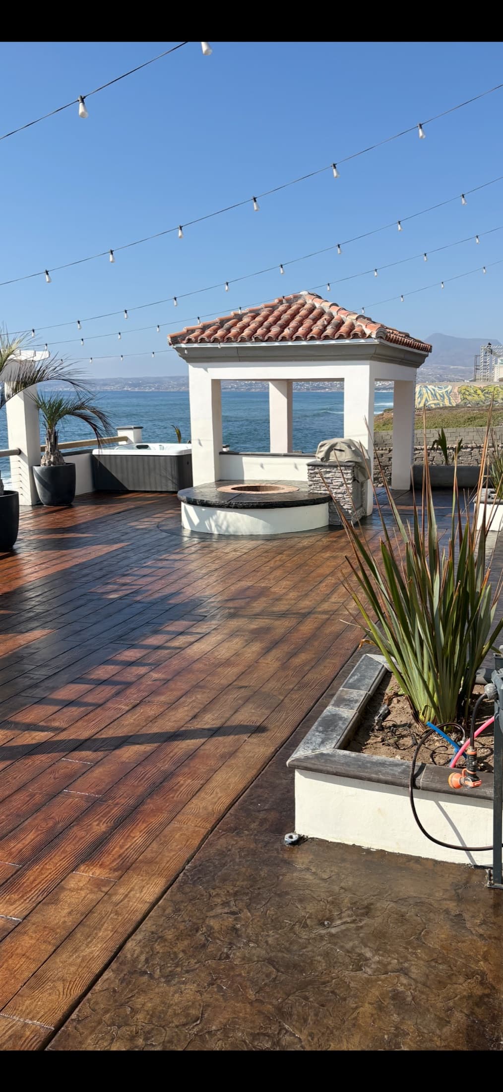 Ocean-view deck with pergola and fire pit