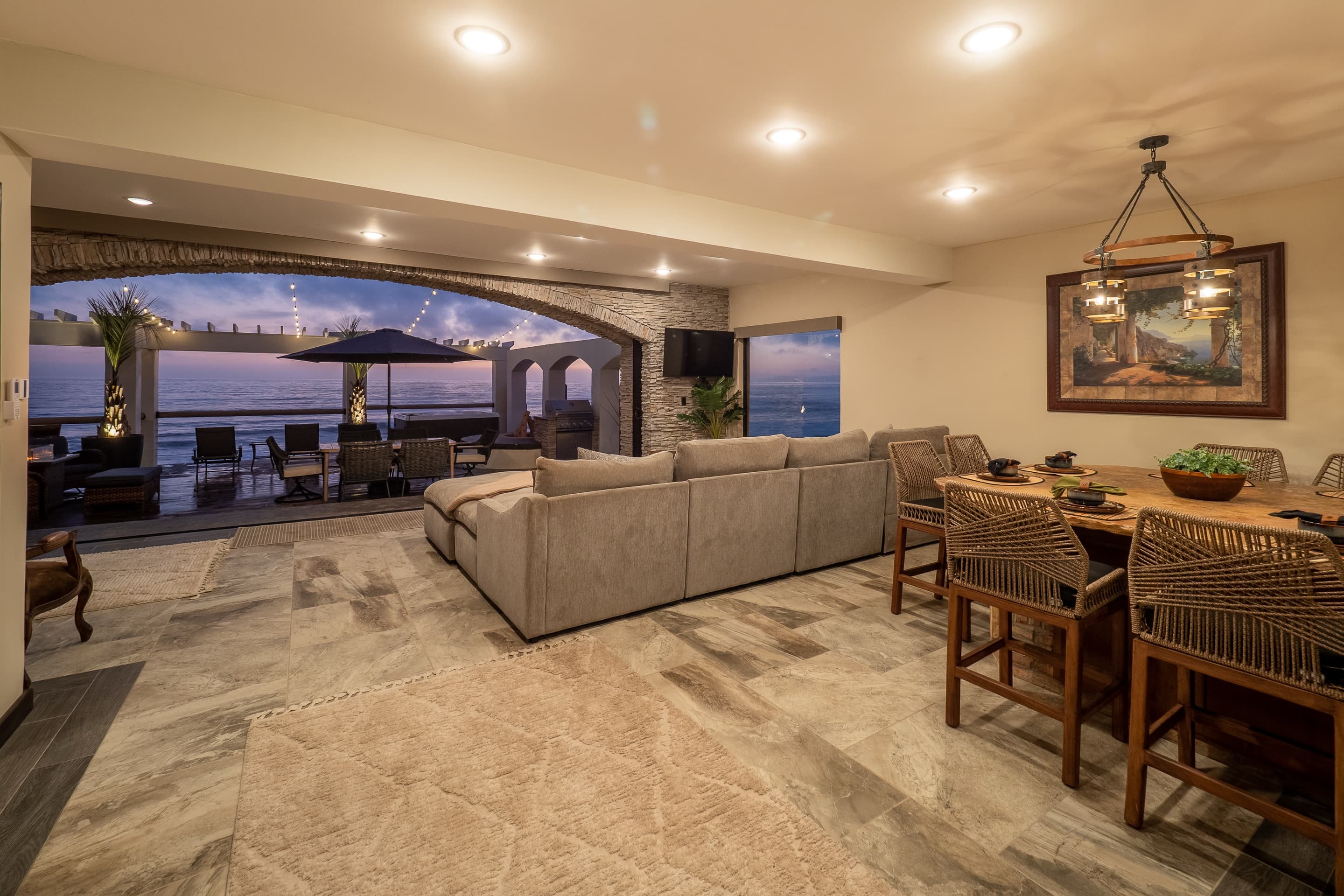 Open living and dining room with travertine floors
