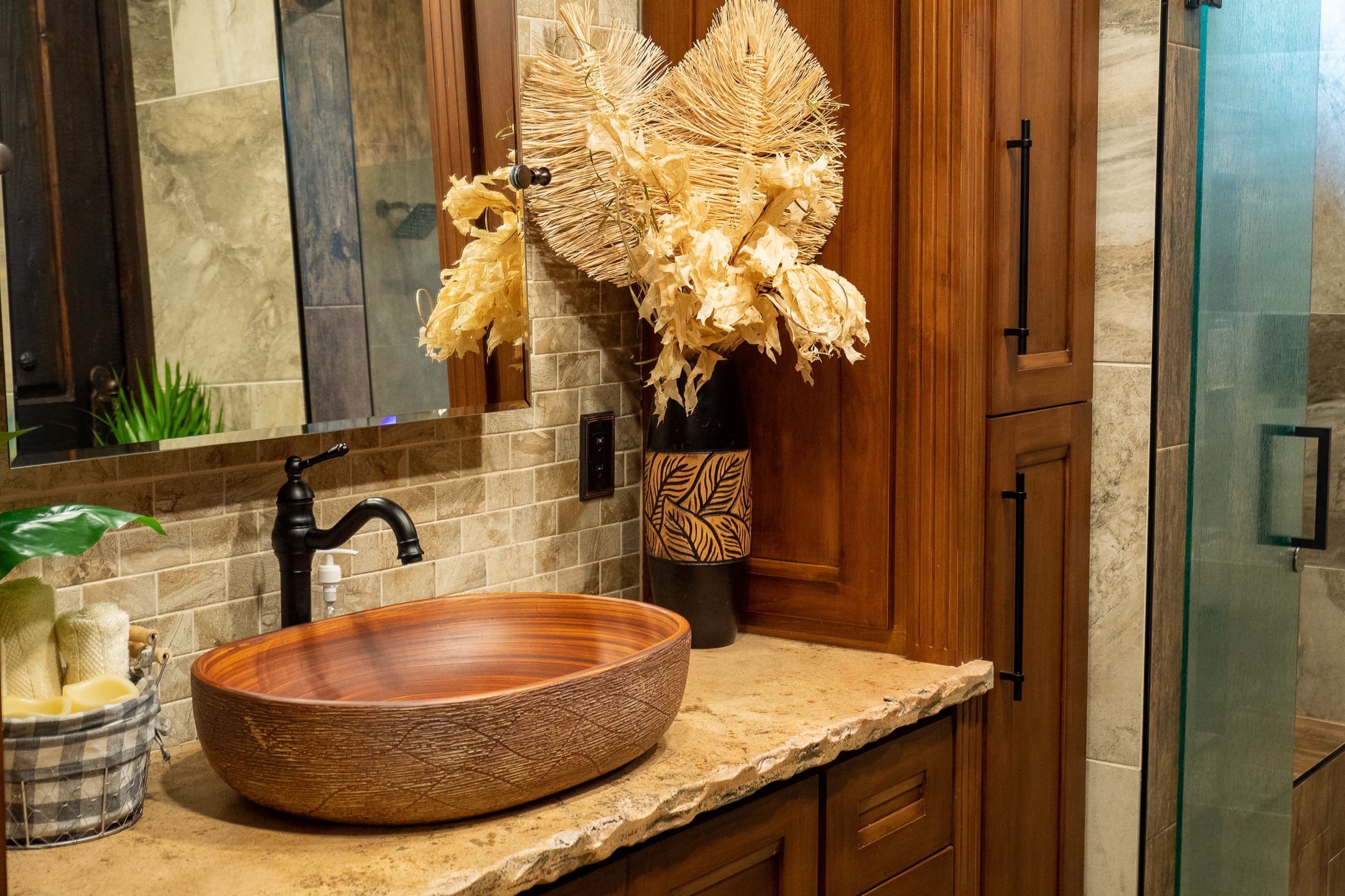 Bathroom with copper vessel sink and stone tile